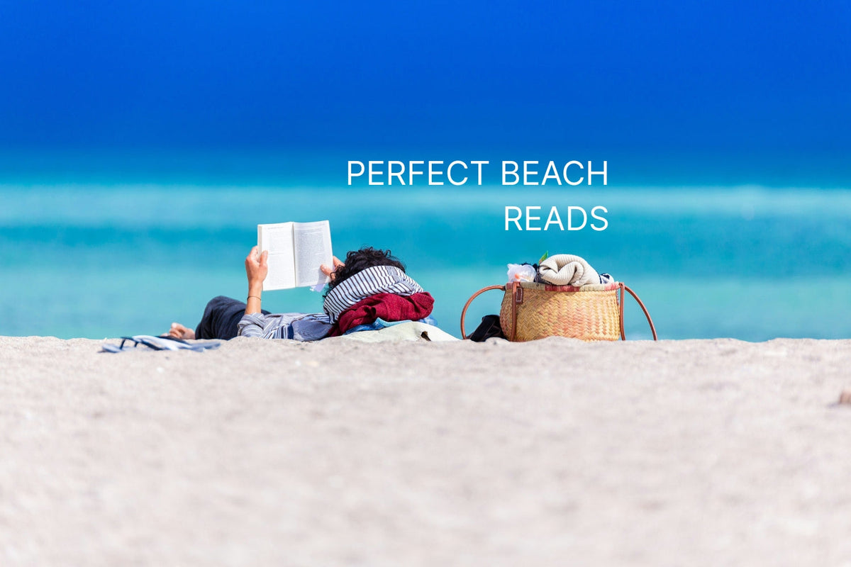 Person reading a book on the beach on a sunny day