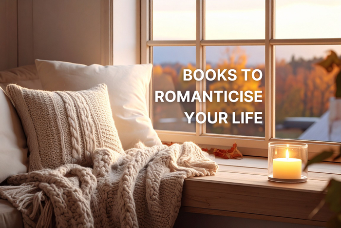 a cosy window seat with candles, pillows and blankets with a text overlay saying 'books to romantacise your life'